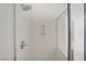 Modern shower featuring marble-style surround, adjustable shower head, and recessed shelving for added convenience and organization at 6625 Pine Siskin Pl, North Las Vegas, NV 89084