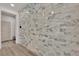 Foyer with an accent wall featuring decorative stone and hardwood flooring at 6643 Tangled Vines Ave, Las Vegas, NV 89139