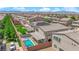 Backyard aerial view showcasing a pool, patio, lush greenery, and the home's exterior in a well-maintained community at 6643 Tangled Vines Ave, Las Vegas, NV 89139
