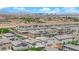 Neighborhood aerial view of homes with desert landscaping, solar panels, and stunning views of the Las Vegas skyline at 6643 Tangled Vines Ave, Las Vegas, NV 89139