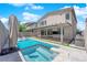 Outdoor oasis featuring a sparkling pool, spa, covered patio, and built-in grill, perfect for entertaining guests at 6643 Tangled Vines Ave, Las Vegas, NV 89139