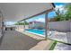 Backyard featuring a covered patio, outdoor kitchen, pool, and spa at 6643 Tangled Vines Ave, Las Vegas, NV 89139