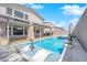 Stunning backyard featuring a private pool, spa, covered patio, and outdoor kitchen for ultimate relaxation and entertaining at 6643 Tangled Vines Ave, Las Vegas, NV 89139