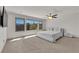 Bright bedroom featuring neutral decor, with large windows and ceiling fan at 6643 Tangled Vines Ave, Las Vegas, NV 89139