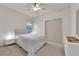 Bright bedroom with neutral tones, a ceiling fan, and a double-door closet at 6643 Tangled Vines Ave, Las Vegas, NV 89139