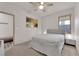 Bedroom with a ceiling fan and bedside table next to the plush bed at 6643 Tangled Vines Ave, Las Vegas, NV 89139