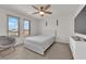 Well-lit bedroom features a ceiling fan, neutral walls, carpet, and comfortable furniture at 6643 Tangled Vines Ave, Las Vegas, NV 89139