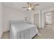 Bedroom showcasing a bed with an upholstered headboard, ceiling fan, and neutral decor at 6643 Tangled Vines Ave, Las Vegas, NV 89139