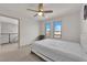 Bright bedroom with a ceiling fan, carpet flooring, and natural light through large windows at 6643 Tangled Vines Ave, Las Vegas, NV 89139