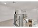 Second floor hallway with modern railings, and view to the living room below at 6643 Tangled Vines Ave, Las Vegas, NV 89139