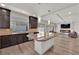 Open kitchen features granite countertops, a large island, and access to the living area at 6643 Tangled Vines Ave, Las Vegas, NV 89139