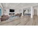 Bright, open-concept living room boasts wood floors, a modern fireplace, and dining area at 6643 Tangled Vines Ave, Las Vegas, NV 89139