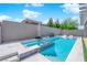 Inviting pool and spa area featuring modern tile work and ample space for relaxation on a sunny day at 6643 Tangled Vines Ave, Las Vegas, NV 89139