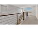 Upstairs hallway featuring banister, window, carpeted floors, and marble-look wall at 6643 Tangled Vines Ave, Las Vegas, NV 89139