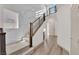 Staircase with carpet steps, wood handrail, and modern white and marble accents at 6643 Tangled Vines Ave, Las Vegas, NV 89139