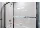 Updated bathroom features a tiled shower with glass door and chrome fixtures at 695 Orbiter Ln, Las Vegas, NV 89148