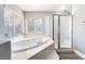 Bathroom boasts soaking tub with large window, plus shower with a glass door at 695 Orbiter Ln, Las Vegas, NV 89148