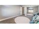 Cozy bedroom features a round rug, carpet floors, and a mirrored closet at 695 Orbiter Ln, Las Vegas, NV 89148