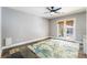 Spacious bedroom with slate flooring, French doors leading to a patio and ceiling fan at 695 Orbiter Ln, Las Vegas, NV 89148