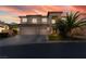 Attractive two-story home featuring a three-car garage and a well-maintained front yard at 695 Orbiter Ln, Las Vegas, NV 89148