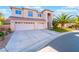 Beautiful two-story home with a three-car garage and well-manicured landscaping at 695 Orbiter Ln, Las Vegas, NV 89148