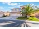 Charming two-story home with a three-car garage and a well-maintained lawn at 695 Orbiter Ln, Las Vegas, NV 89148