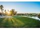 Lush green golf course with a serene pond and backdrop of palm trees, perfect for a relaxing game at 695 Orbiter Ln, Las Vegas, NV 89148