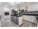 Bright kitchen with white cabinetry, granite countertops, stainless steel appliances, and a central island at 695 Orbiter Ln, Las Vegas, NV 89148