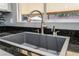 Close-up of a modern kitchen sink with granite countertops and a view of the outdoor patio at 695 Orbiter Ln, Las Vegas, NV 89148
