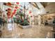 Grand lobby featuring a skylight, marble floors, and indoor plants, decorated with hanging Chinese lanterns at 695 Orbiter Ln, Las Vegas, NV 89148
