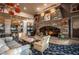 Cozy lounge area with a stone fireplace and comfortable seating, creating a relaxing atmosphere at 695 Orbiter Ln, Las Vegas, NV 89148
