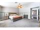 Spacious main bedroom with carpet floors, neutral paint, and ceiling fan at 695 Orbiter Ln, Las Vegas, NV 89148