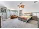 Spacious main bedroom with carpet floors, a ceiling fan, and seating area at 695 Orbiter Ln, Las Vegas, NV 89148
