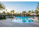 Large community pool surrounded by lush palm trees and various amenities offering an oasis for relaxation and recreation at 695 Orbiter Ln, Las Vegas, NV 89148