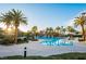Beautiful community pool area with palm trees, seating, and sunlit surroundings providing a resort-style experience at 695 Orbiter Ln, Las Vegas, NV 89148