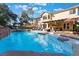 Inviting backyard pool with rock waterfall feature, patio, and outdoor seating at 695 Orbiter Ln, Las Vegas, NV 89148