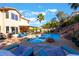 Stunning backyard pool and spa area with rock features, outdoor seating, and lush landscaping perfect for relaxing at 695 Orbiter Ln, Las Vegas, NV 89148