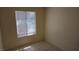 Cozy bedroom with neutral walls and floors, and a window providing natural light at 7053 Magic Moment Ln, Las Vegas, NV 89119