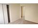 Cozy bedroom with closet and adjoining room visible, featuring neutral walls and flooring at 7053 Magic Moment Ln, Las Vegas, NV 89119