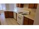 Functional kitchen with ample counter space, white appliances, and tile flooring at 7053 Magic Moment Ln, Las Vegas, NV 89119