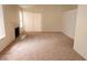Spacious living room featuring carpet floors, a fireplace, and a sliding glass door for natural light at 7053 Magic Moment Ln, Las Vegas, NV 89119