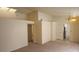 Spacious living room featuring neutral walls, carpet flooring, and a modern chandelier at 7053 Magic Moment Ln, Las Vegas, NV 89119