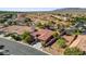 Aerial view of a home with lush landscaping, a tile roof, and desert surroundings at 7204 Royal Melbourne Dr, Las Vegas, NV 89131