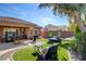 Backyard with an outdoor dining and lounge area, featuring an adjacent hammock at 7204 Royal Melbourne Dr, Las Vegas, NV 89131
