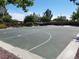 Community basketball court ready for a pick-up game with shaded spots to sit and relax at 7204 Royal Melbourne Dr, Las Vegas, NV 89131