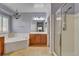 Charming bathroom featuring a soaking tub, a shower, and elegant light fixtures at 7204 Royal Melbourne Dr, Las Vegas, NV 89131