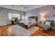 Comfortable bedroom with a plush bed, chaise lounge, and bright windows at 7204 Royal Melbourne Dr, Las Vegas, NV 89131