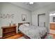 Comfortable bedroom with a wooden bed frame and adjacent en-suite bathroom at 7204 Royal Melbourne Dr, Las Vegas, NV 89131