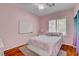 Cozy bedroom with a plush bed, bright windows, and a pink accent wall at 7204 Royal Melbourne Dr, Las Vegas, NV 89131