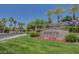Community entrance sign for Silverstone Ranch, framed by colorful flowers and palm trees at 7204 Royal Melbourne Dr, Las Vegas, NV 89131